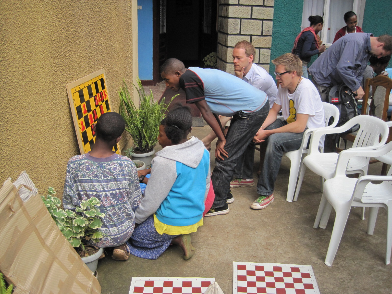 Outdoor Chess Learning Activity Young people and instructors take part in an outdoor chess learning activity.